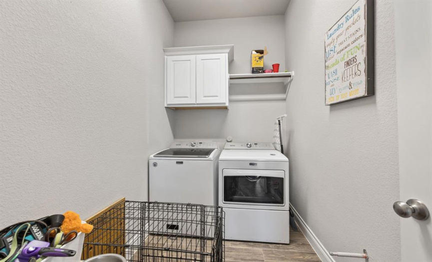 The in-home laundry room is located next to the full guest bathroom. 