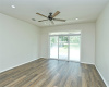 Updated ceiling fan and recessed lighting overhead in living room.