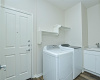 Laundry room includes a useful wash basin.
