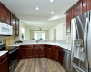 Kitchen includes Corian countertops and stately wood cabinets.