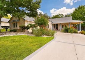 The Brazos floor plan offers a wrap-around front porch and side entry garage.