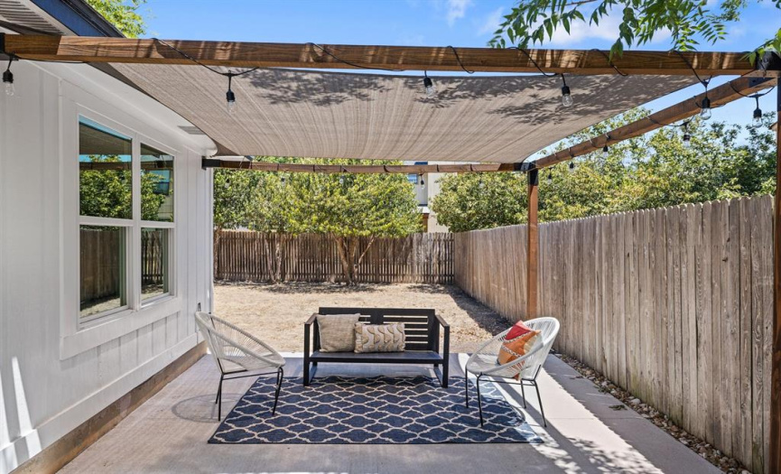 Step outside to your spacious backyard, where a covered patio beckons for relaxation & enjoyment.