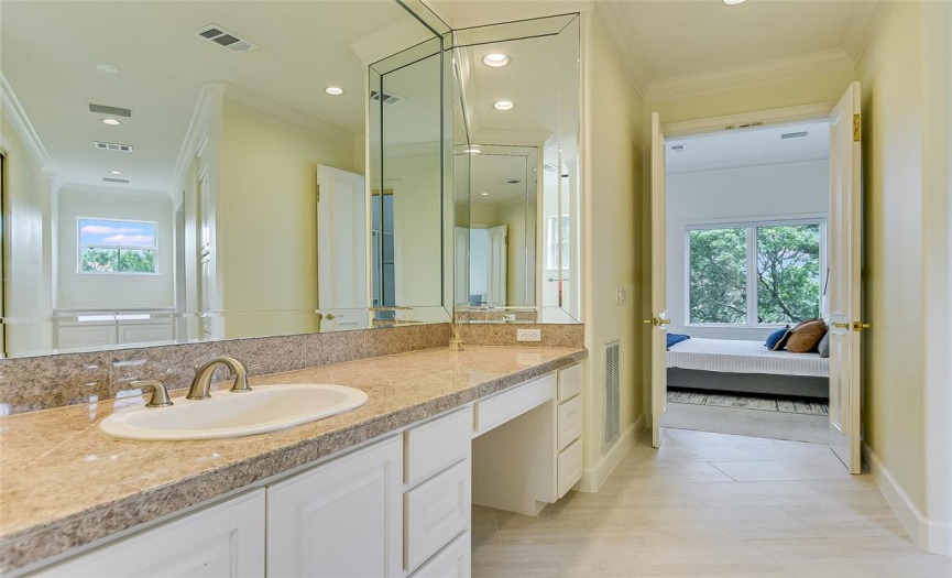 Entrance of en suite primary bathroom. Bathroom includes two vanities, two walk-in closets, soaking tub, walk-in shower, and ample storage space.