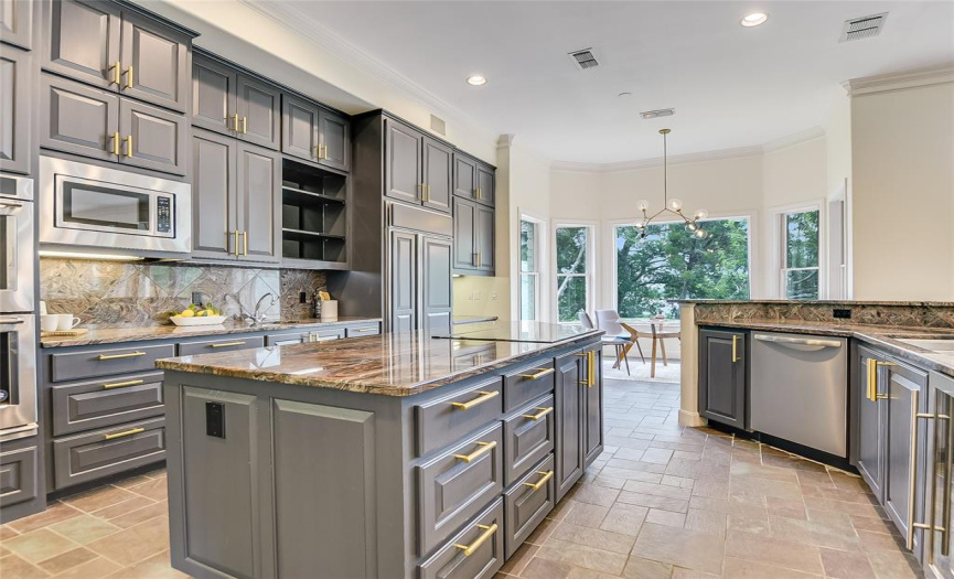 Large kitchen with upgraded granite countertops and stainless steel appliances.