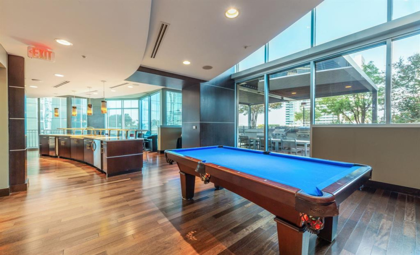 The clubroom features a pool table, seating area, and catering kitchen.
