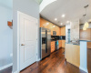 The kitchen features a lot of storage space and a breakfast bar with pendant light fixtures.
