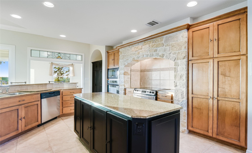 The well appointed kitchen will be appreciated by every family chef!  Ample cabinets, a custom alcove for your cooking area, and plenty of countertop space for prep at the kitchen island.