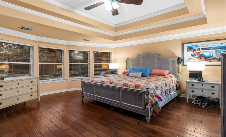 Primary bedroom showcases the stunning craftsmanship and crown molding