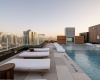 Outdoor lounge seating wraps around the rooftop swimming pool