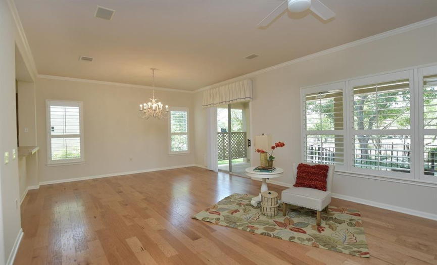 Enjoying nice views of the greenbelt behind this home, plantation shutters stand on their own in the living/dining area and throughout the entire home.