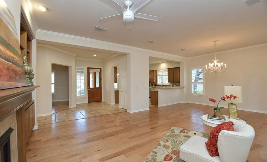 A small foyer with study to one side and island kitchen to the other is found in this popular floor plan.