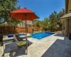 The patio opens up to a backyard oasis that boasts a sparkling pool and spa, surrounded by beautifully landscaped xeriscaping (backyard only) that evokes a sense of calm and escape