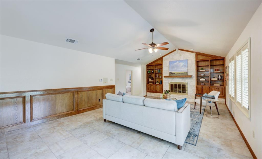 Large living area with high ceilings and fireplace. Perfect for entertaining or spending time with the family.