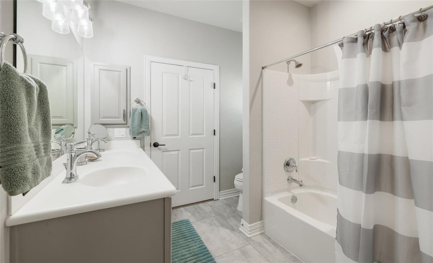A Jack and Jill bath offers ample counter space and dual vanities.