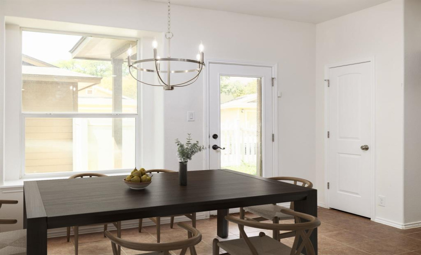 The dining area adjacent to the kitchen has nice light and windows to the backyard. 