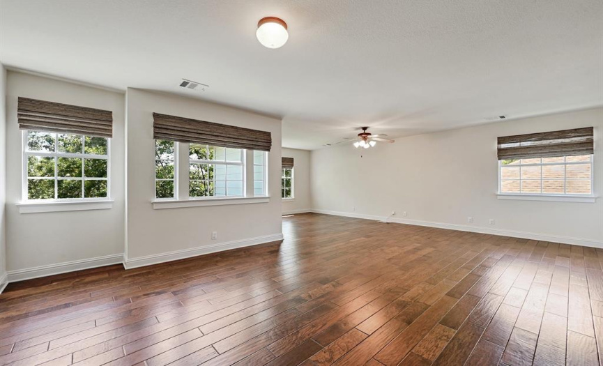 Upstairs, media play room with gorgeous wood floors