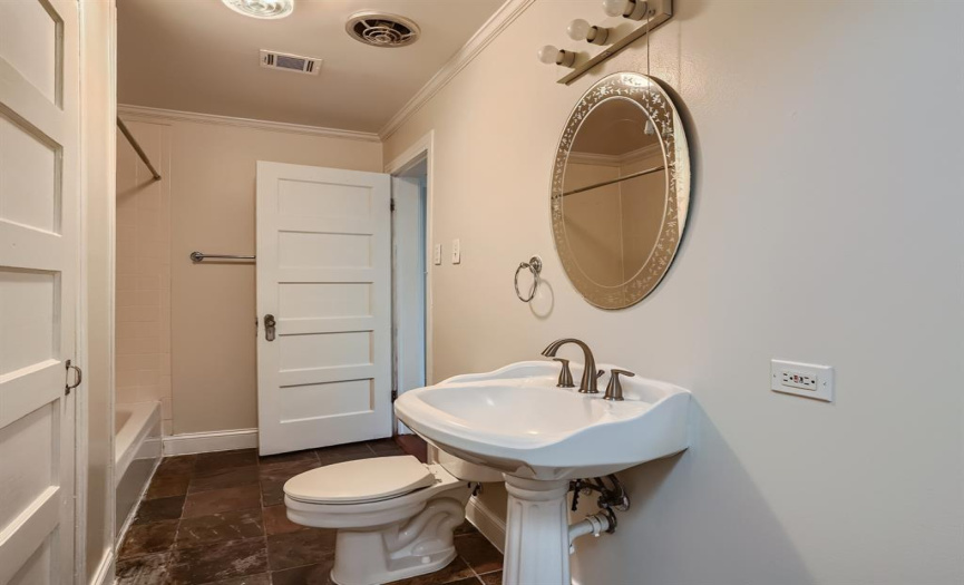 The full bath in the main house offers a shower/tub combo and pedestal sink. 