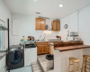 The kitchenette in the middle unit features a breakfast bar with seating for two. This unit also offers a washer & dryer hookup for convenient in-unit laundry. 