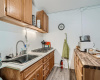 The kitchenette comes equipped with a gas cooktop, sink, and great cabinetry storage and counter space. 
