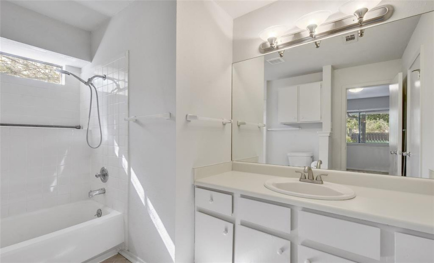 PRIMARY BATHROOM WITH A WALK-IN CLOSET....NICE WINDOW FOR NATURAL LIGHT ABOVE THE TUB...