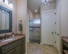 The master bath features dual vanities and an oversized walk-in shower with frameless glass door.