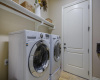 The utility room has tall ceilings and additional storage.