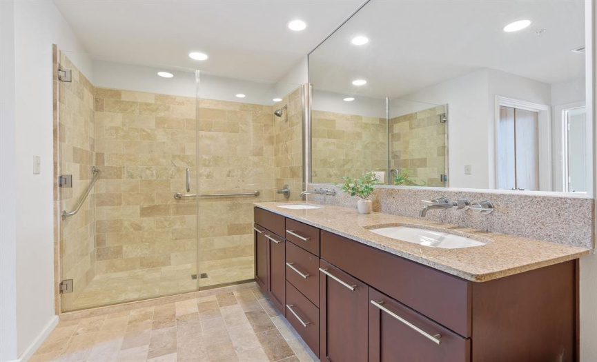 Dual vanities and spacious walk-in shower.