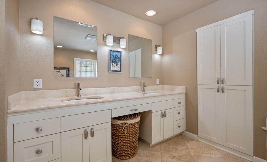 Updated primary bath with double vanities, updated lighting, faucets, knee space, plus linen closet