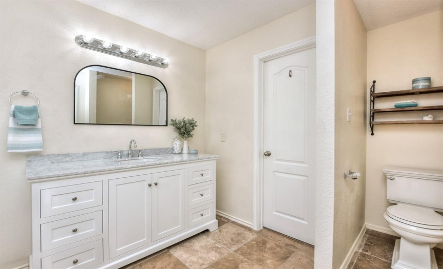 Doorway leads to a large walk-in closet and there is a private area for the commode...