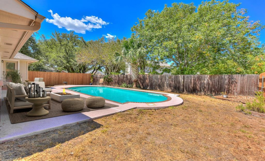 This photo has been virtually staged.  Great backyard and covered patio for watching the kiddos swim...or just get your raft and float the day away!