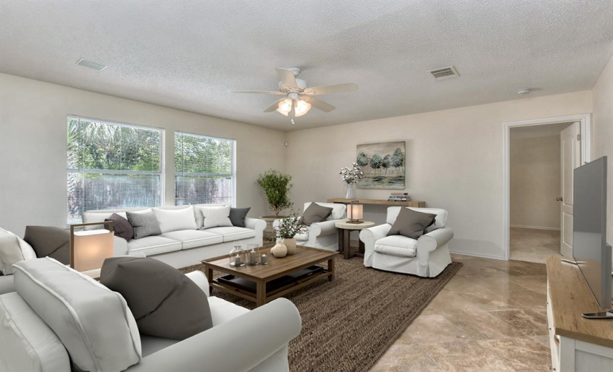 This photo has been virtually staged.  These furnishings help show you what this room can be.  Spacious family room has double windows with a view of the pool & outdoor living...