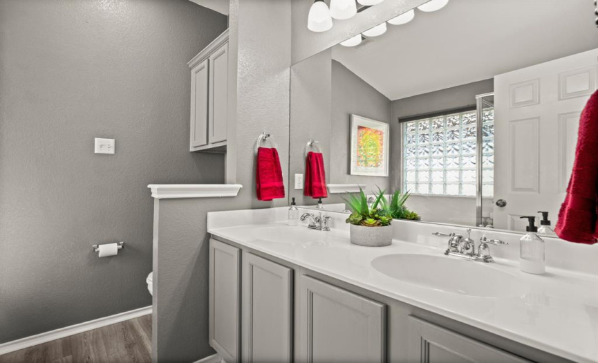 Enjoy your own private ensuite bathroom with a spacious dual vanity and vinyl plank flooring. 