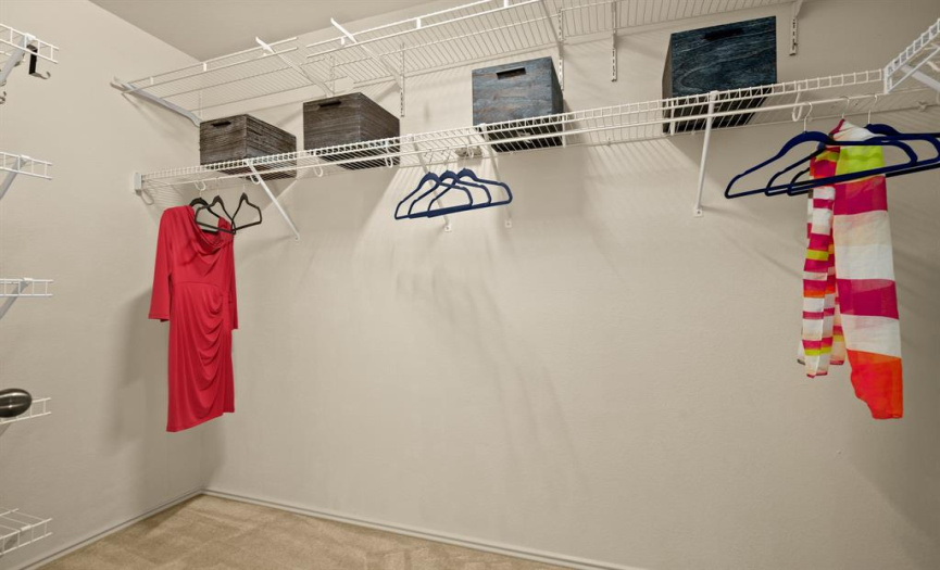 The walk-in closet offers convenient built-in shelving. 