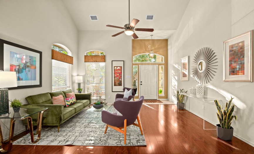 Two-story high ceilings and plentiful oversized picture windows create an atmosphere of grandiosity and allows an abundance of natural light to flood in through numerous windows. 