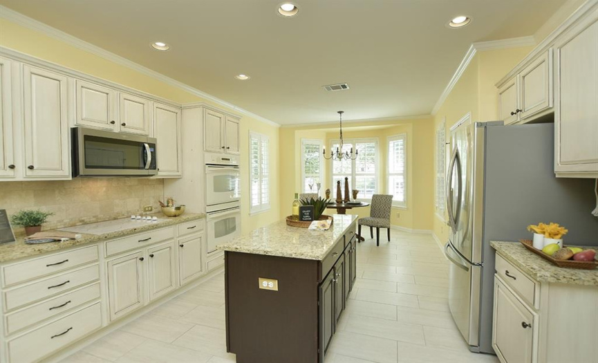 Creamy cabinets combine with granite counter tops to provide a pleasing place to spend time.