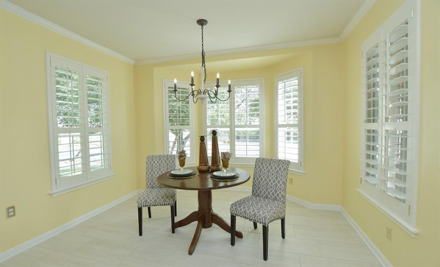 Plantation shutters highlight each window in this lovely home, making no other window treatment necessary.