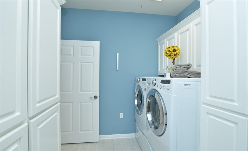 In the utility room, handsome cabinetry was added to provide extra storage space for whatever your needs may be.  Washer/dryer on pedestals will convey with the home.