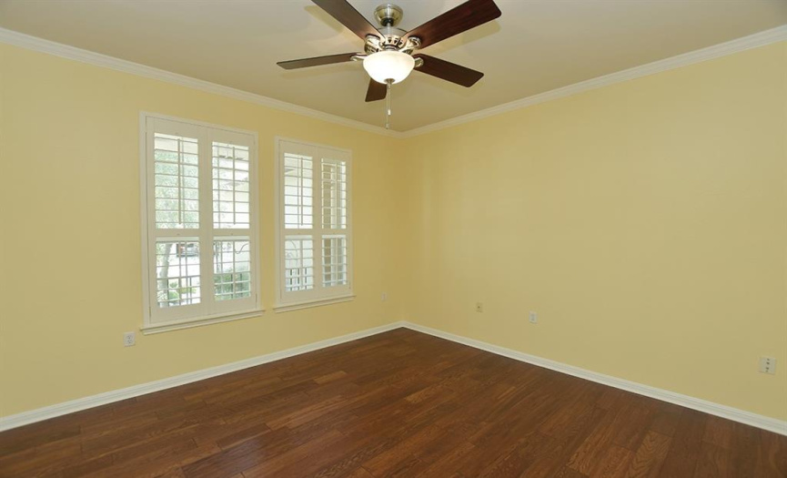 Looking out front, the study is located off the foyer and features wood floors, plantation shutters and crown molding.  Make it a home office or perhaps another living space.
