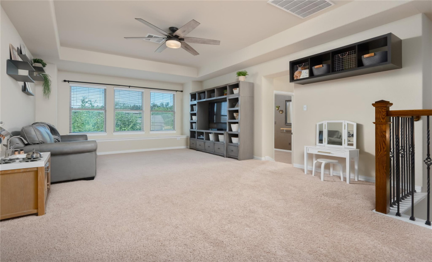 Large upstairs game room/secondary living space with tray ceiling