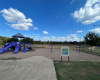 Lot backs up to park with playscape and picnic area
