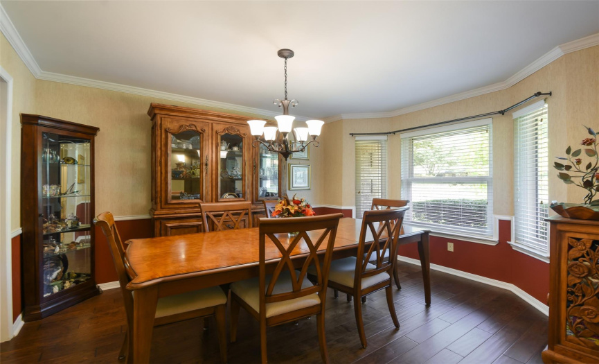 Formal dining with hardwood floors and crown molding