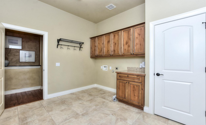Oversized laundry room with a folding counter.