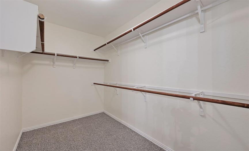 Large walk in closet attached to primary bathroom
