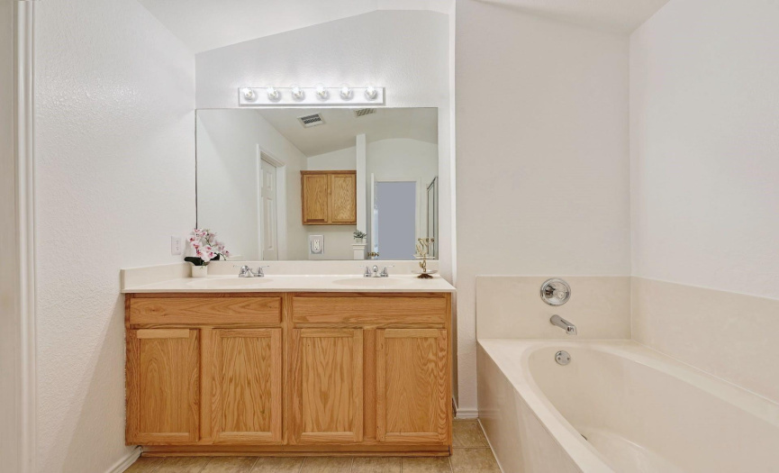 The ensuite offers a dual vanity with ample storage space.