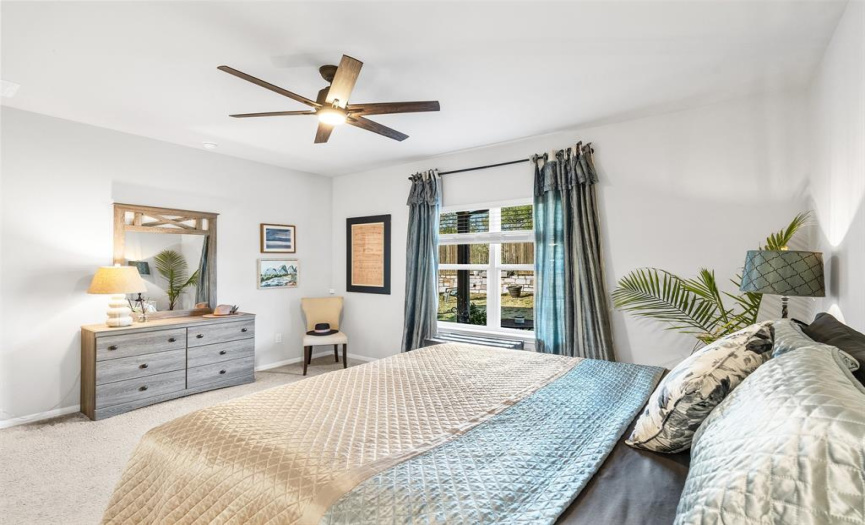 The primary bedroom also offers views just into McKinney Falls State Park which is located directly behind the home.