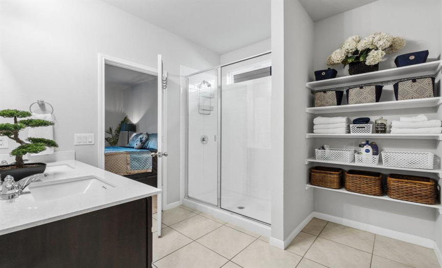 The primary bathroom offers ample storage and a touch of luxury. 