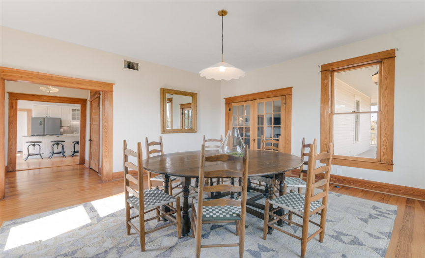 A large, formal dining space can be found through the butlers pantry, and off of the side of the informal living space.  Glass, French doors can close off the space if needed