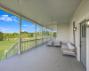 The oversized, deep porch has a view out over the grassy acreage and hill country beyond