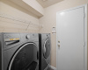 The laundry room is equipped with an overhead shelf for storage needs.