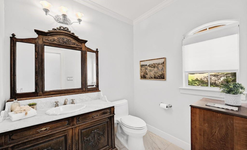 The half bath off of the kitchen has an antique dresser vanity.  Such a unique, timeless touch. 